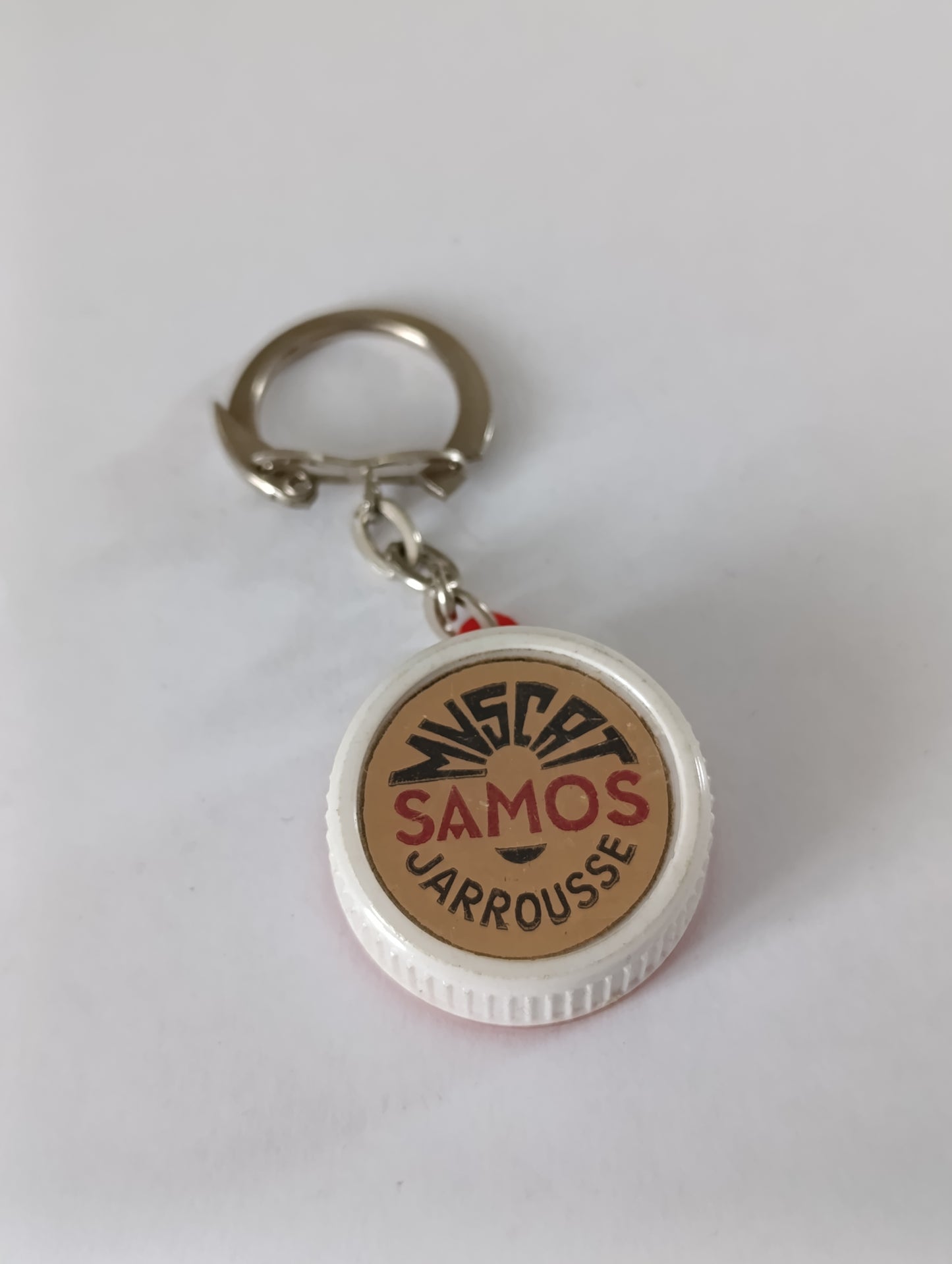 Porte-clés publicitaire ancien Nigra Samos Jarousse capsule