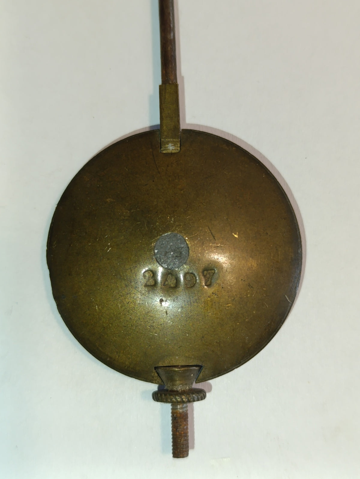 Petit balancier ancien de pendule à lentille ronde et tige métallique