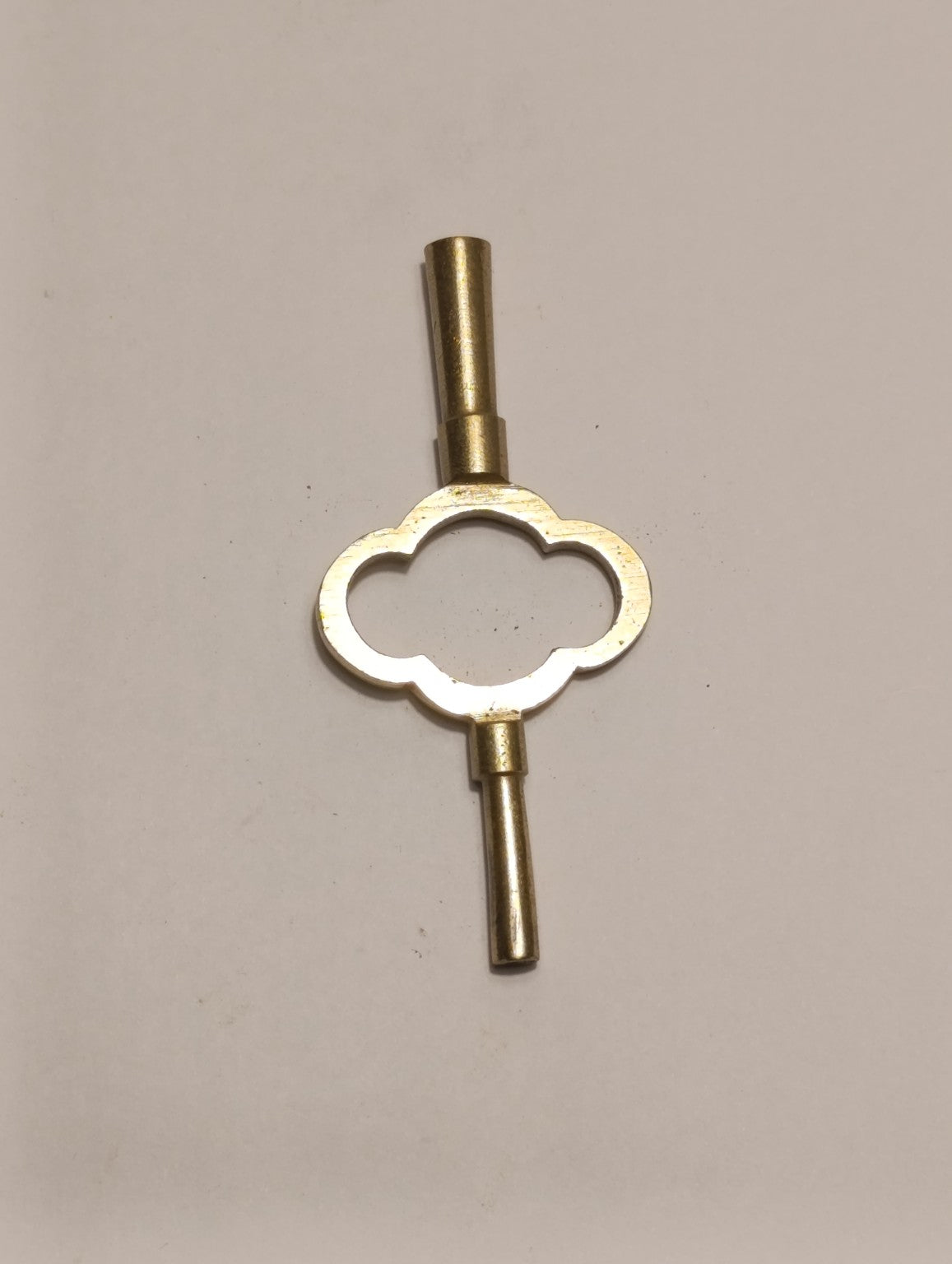 Clé double ancienne de remontage pour pendule — poignée à quatre lobes, embouts à collerettes — recto